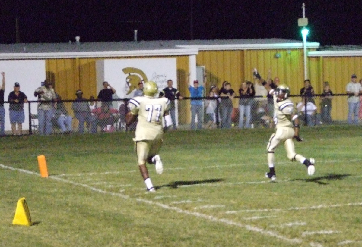 Image: Larry Mayberry(77) turns an interception into 6-points for the Gladiators while being escorted to the endzone by Eric Carson(24). What a great moment for this senior!