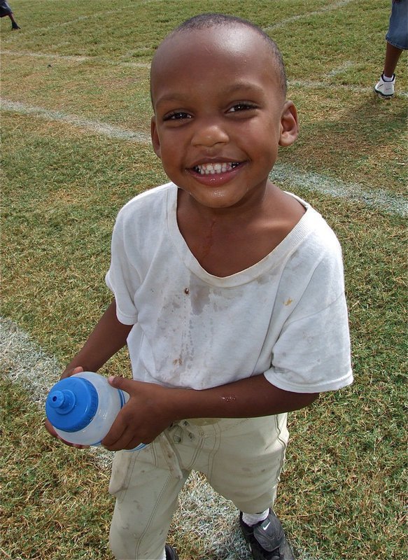 Image: C-Team player Curtis Benson enjoys being a waterboy for the A-Team and personally checks the water throughout the game to make sure it is still cold.