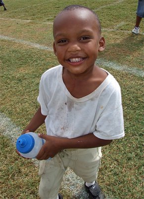 Image: C-Team player Curtis Benson enjoys being a waterboy for the A-Team and personally checks the water throughout the game to make sure it is still cold.