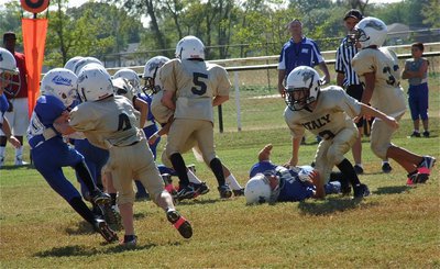 Image: The B-Team Gladiators have earned two-straight wins in large part to their improved blocking effort as Bryce DeBorde(4) and Preston Rasco(9) knock a couple of Lion defenders down.