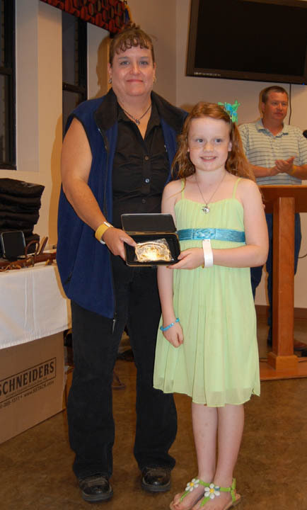 Image: Sadie Hinz of Italy, right, receives a buckle for Champion Walk &amp; Whoa.