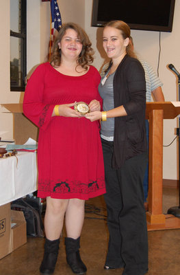 Image: ECEA youth vice president Liz Terry, right, presents Alyssa Ballew of Midlothian with the Nancy Jessup Sportsmanship Award buckle. Alyssa and Liz are both riding students at the Flying Dollar Ranch.
