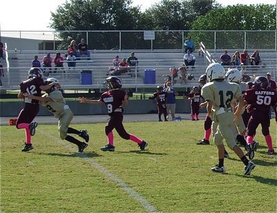 Image: Preston Rasco(9) tackles an Eagle Runner in the backfield for the IYAA B-Team (3rd &amp; 4th grades) Gladiators.