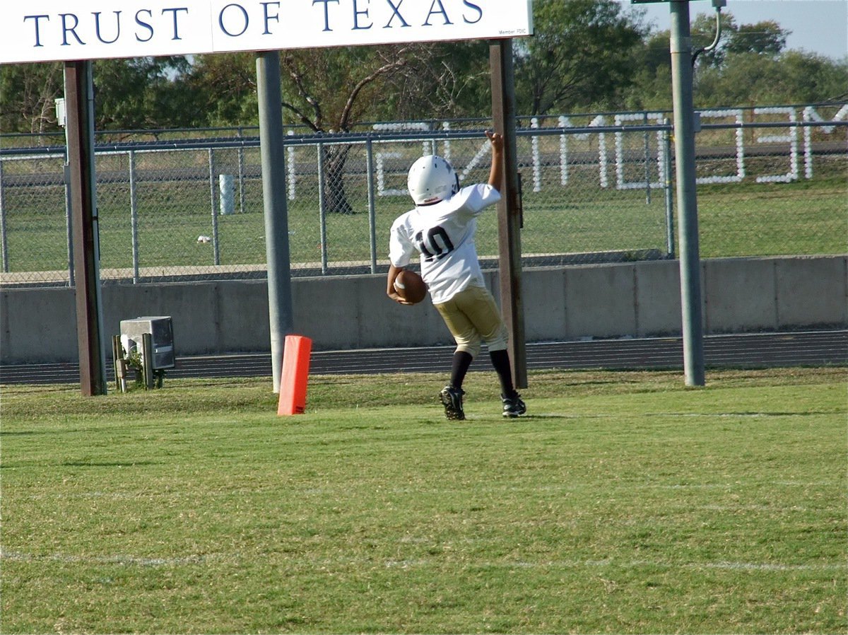 Image: C-Team quarterback Laveranues Green(10) displays the #1 sign after reaching the endzone.