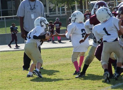 Image: Isaac Gray(30) experiences an offensive lineman’s dream and takes the handoff from Jaylon Wallace(2) before rumbling ahead for several yards.