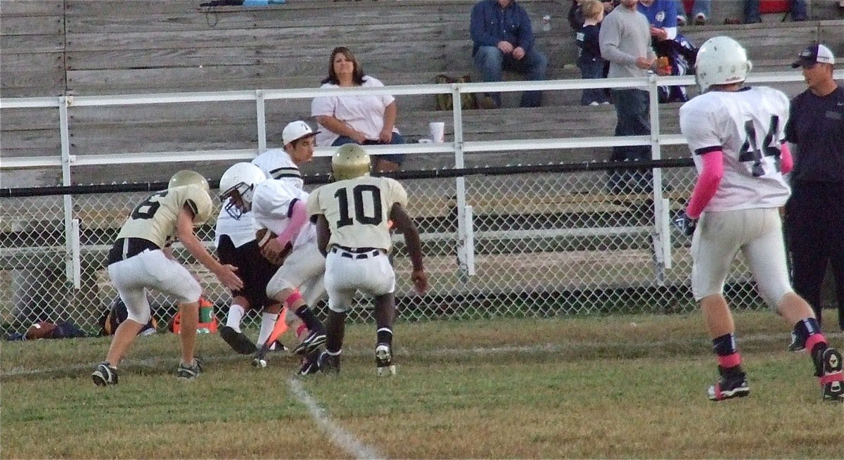 Image: Cody Boyd(36) tackles a loose Cougar with teammate Marvin Cox(10) rushing over to assist.