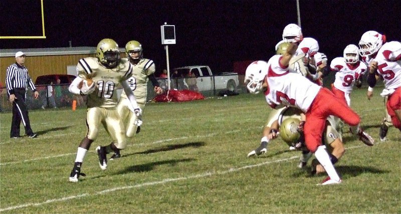 Image: Gladiator Chase Hamilton(2) cuts down a Longhorn defender to make room for tailback Ryheem Walker(10).