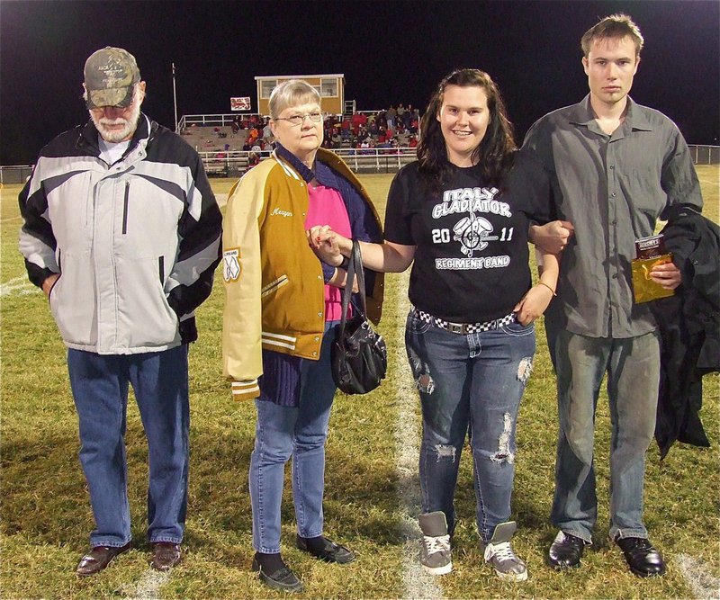 Image: Gladiator Regiment Marching Band senior, Meagan Buchanan, manages a smile before her final home game.
