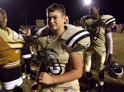 Image: Sophomore Zain Byers(50), Senior Larry Mayberry, Jr.(77) and their teammates get congratulated by fellow IHS students as they exit Willis Field after defeating the Axtell Longhorns 36-26.