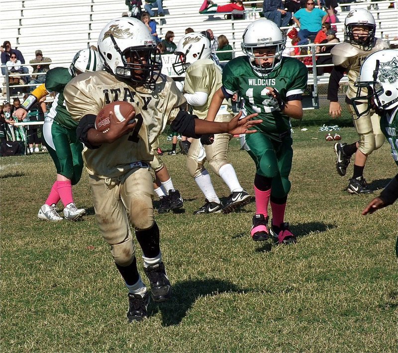 Image: IYAA B-Team Gladiator, Ricky Pendleton(21), tries to maneuver past a Wildcat defender.