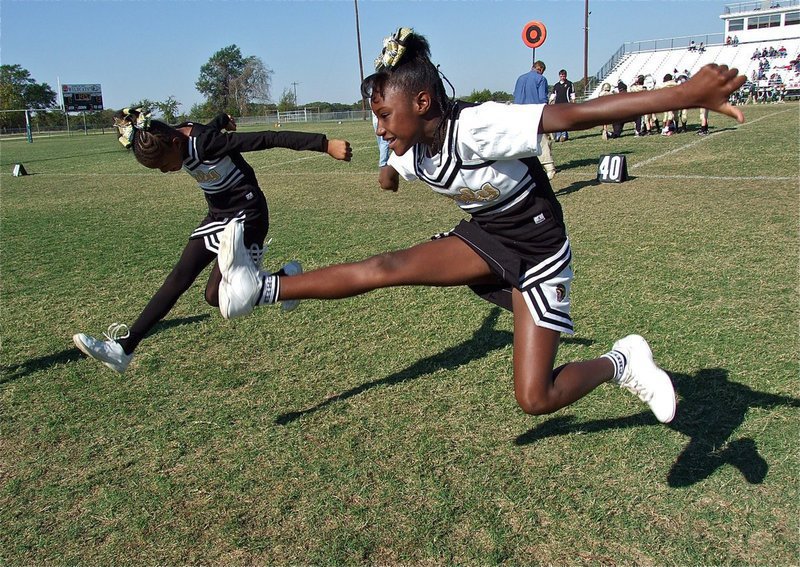 Image: IYAA B-Team cheerleaders Destiny Harris and Shaniaya Johnson gain altitude after their cheer.