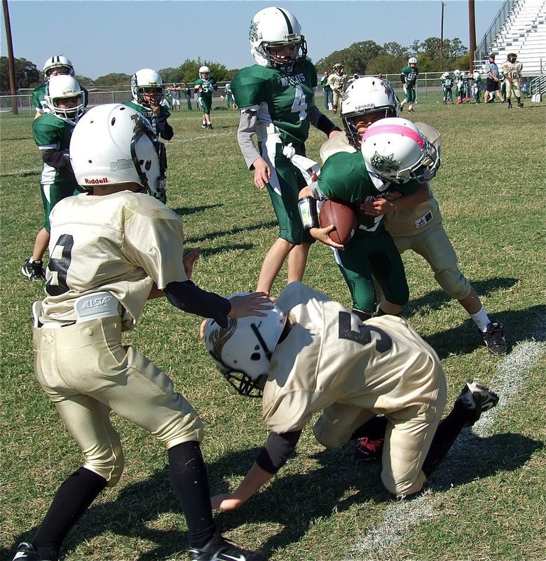 Image: Preston Rasco(9) and Eric Martinez(5) slow down a Wildcat runner allowing teammate Michael Gonzalez(22) to deliver a hit.