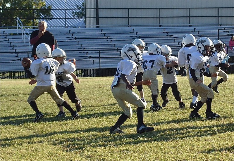 Image: C-Team quarterback Laveranues Green(10) aborts his pass attempt, breaks two tackles and runs for a 53-yard touchdown.