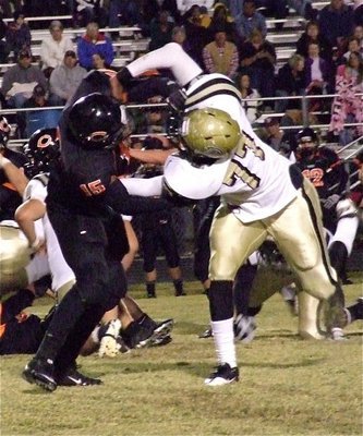 Image: Centerville’s defensive end Jamal High(15) has his hands full with Gladiator right tackle Larry Mayberry, Jr.(77) who drives High away from the play.