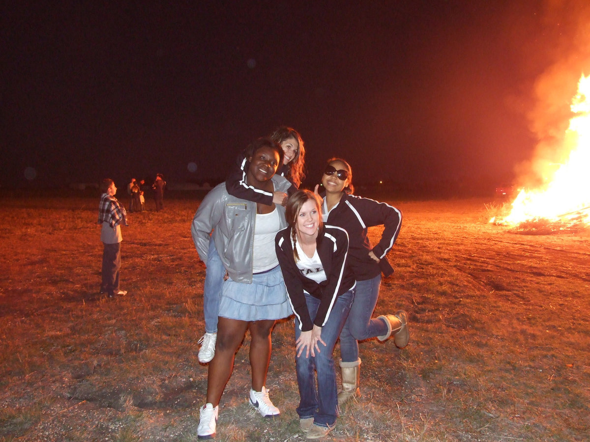 Image: Senior Jimesha Reed shows off her cheerleading skills with Senior IHS Cheerleader Beverly Barnhart, Kaitlyn Rossa and Destani Anderson.
