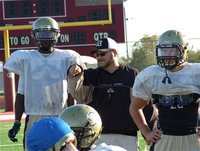Image: Gladiator head coach, Craig Bales, talks with free safety, Devonta Simmons, during Thursday’s practice session at Ennis High School.