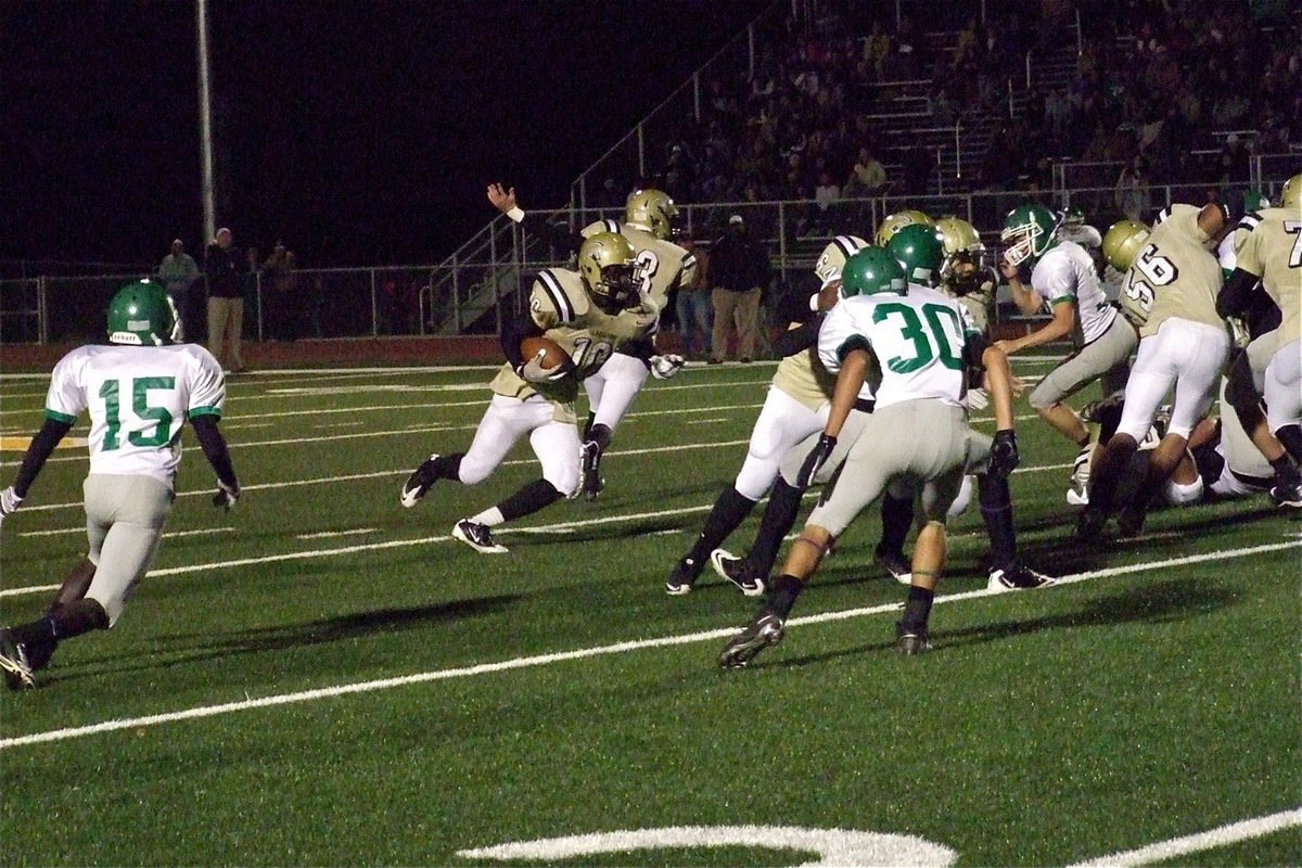 Image: Gladiator quarterback Jase Holden(3) hands off to tailback Ryheem Walker(10) who follows the blocks of Adrian Reed(64), Kyle Jackson(28), Omar Estrada(56), and Larry Mayberry, Jr.(77) in first-quarter action against the Franklin Lions.