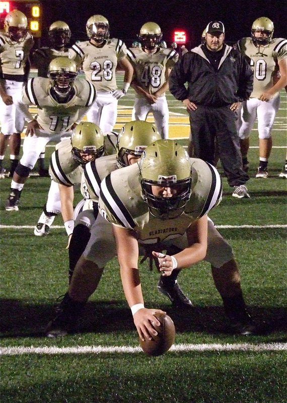 Image: Gladiator head coach Craig Bales monitors the timing of his offense during the pre-game warmups.