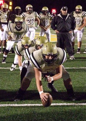 Image: Gladiator head coach Craig Bales monitors the timing of his offense during the pre-game warmups.
