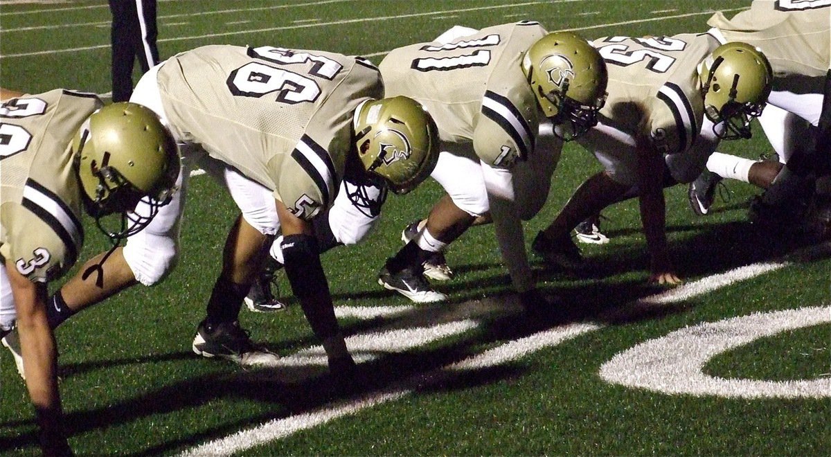 Image: Cody Medrano(32), Omar Estrada(56), Jalarnce Lewis(11) and Shad Newman(25) get set for the game.
