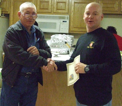 Image: Fire Chief Donald Chambers honors Michael Chambers with a Life Safety Award.