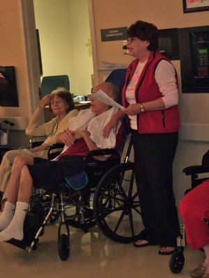 Image: Paula Mandrell (2nd grade teacher) coaching her students as they sing.
