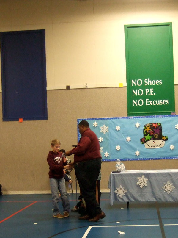 Image: Here is another proud student receiving his awards.