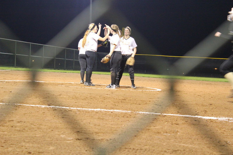 Image: Byers, Bumpus, Megan Richards, Washington, and Lewis get ready to start the inning. 