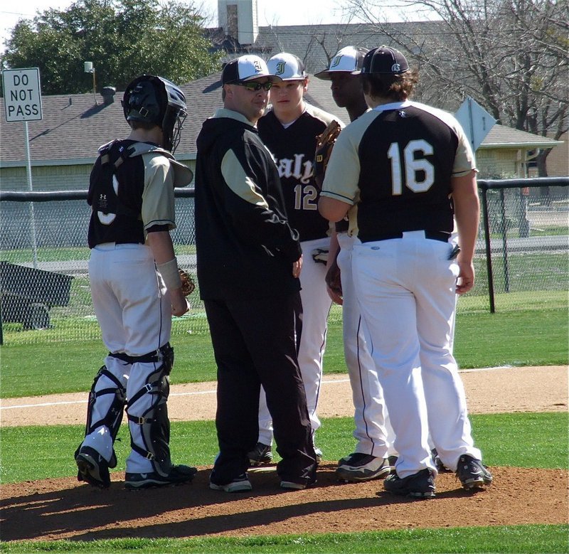 Image: JV Gladiator head coach Josh Ward checks on his pitcher, Marvin Cox(1), as do catcher John Escamilla(3), third baseman John Byers(12) and first baseman Kevin Roldan(16).