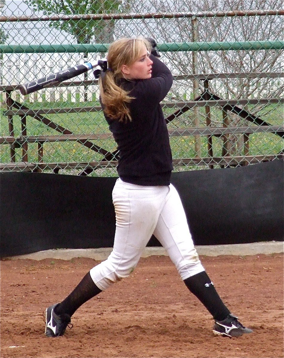Image: Freshman Lady Gladiator slugger Madison Washington gets work done on a sand soaked field.
