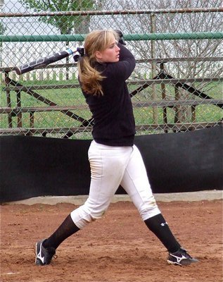 Image: Freshman Lady Gladiator slugger Madison Washington gets work done on a sand soaked field.