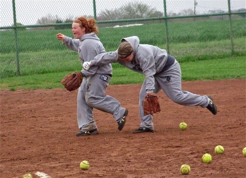 Image: Katie Byers and Paige Westbrook challenge one another for a grounder.