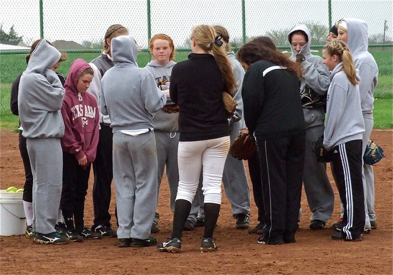 Image: Coach Reeves and Coach Richards talk with the team before ending practice.