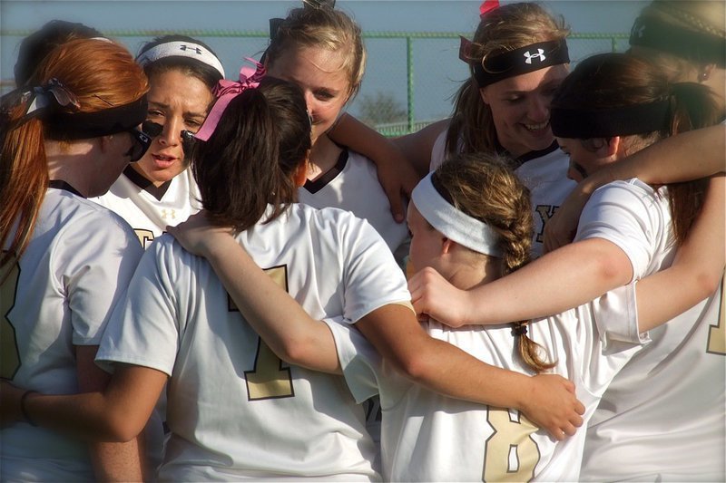 Image: The Lady Gladiators interlock before their 14-3 conquest over Axtell.