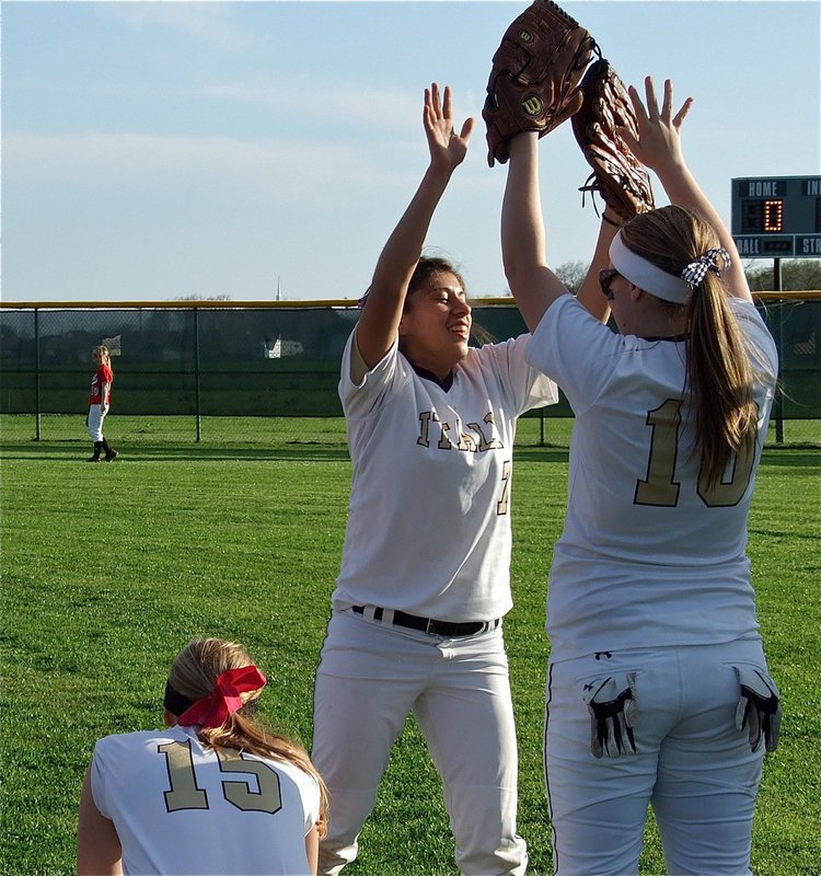 Image: Alma Suaste(7) low fives Jaclynn Lewis(15) and then high fives Paige Wesbrook(10) as the Lady Gladiators get pumped up for their Axtell game.