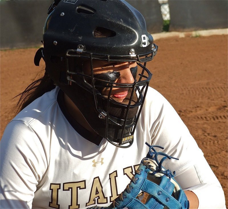 Image: Junior Catcher Alyssa Richards has the look of a seasoned winner as she warms up the pitching arm of her sister, Megan Richards.