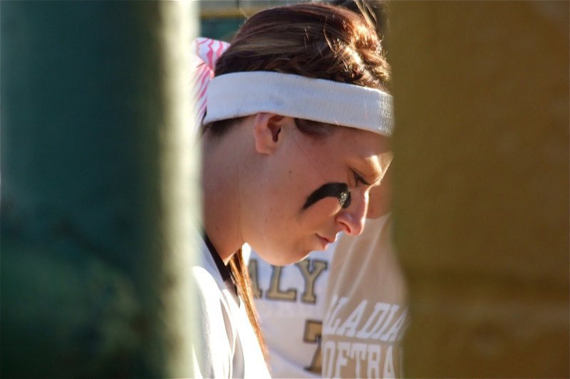 Image: Senior Bailey Bumpus is in deep thought within that tiny void where the fence line ends and the dugout begins.
