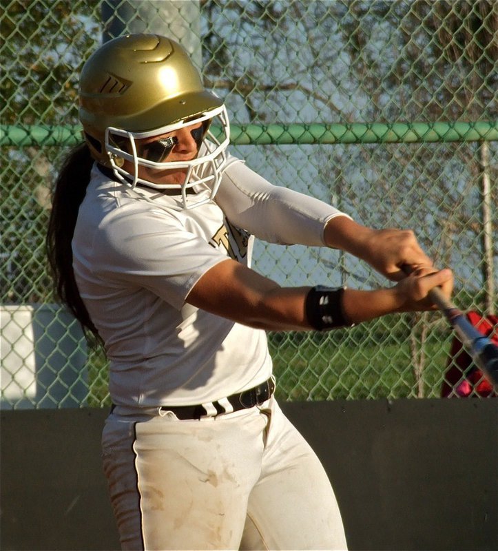 Image: Alyssa Richards blasts a towering ball that lands at the base of the right field fence.