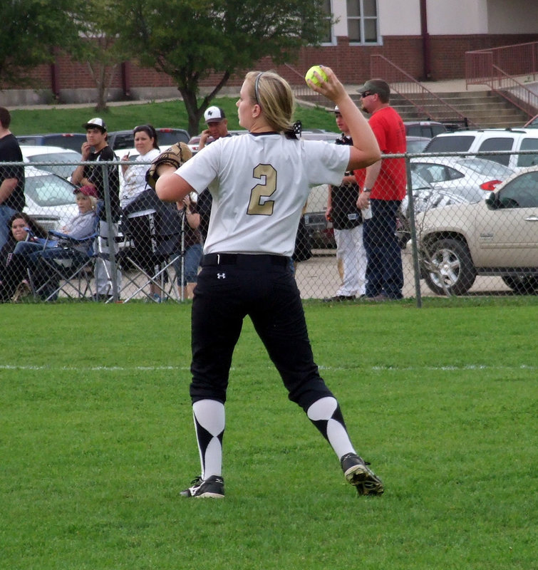Image: Italy’s Madison Washington(2) fields a ball hit to left field.
