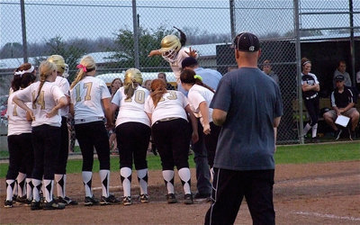 Image: Italy’s Alyssa Richards(9) takes a flying stomp onto home plate after her homerun lap around the bases.