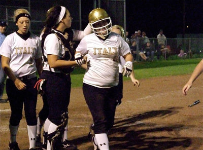 Image: Paige Westbrook(10) gets congratulated by teammate Alyssa Richards(9) after Westbrook blasted her second career over-the-fence homerun beyond the left field fence.