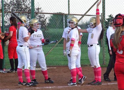 Image: Shop talk during a timeout on the field. Madison Washington(2), Katie Byers(13), Paige Westbrook(10), Jaclynn Lewis(15) and Alyssa Richards(9) compare notes at third base.