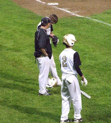 Image: Jase Holden and Caden Jacinto listen to the next plays from Coach Ward.