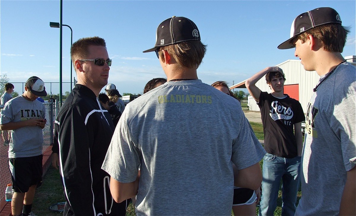 Image: Coach Callahan talks with Jase Holden and Cole Hopkins after their doubles win over Rice.