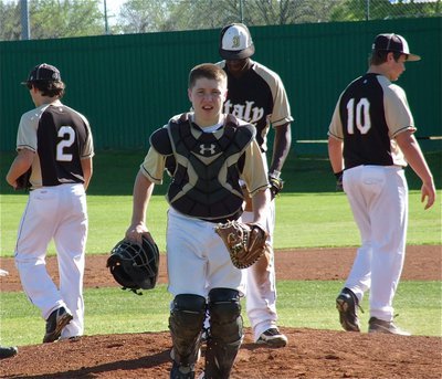 Image: Catcher John Escamilla(5) returns to his office after a meeting with Chace McGinnis(2), Marvin Cox(1) and Zain Byers(10).