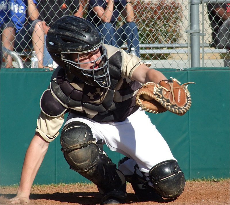 Image: Catcher John Escamilla snags an outside pitch.