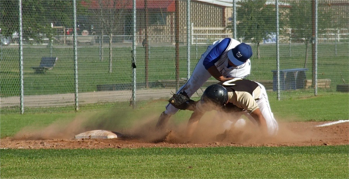Image: Omar Estrada collides with Whitney’s third baseman while trying to steal third.