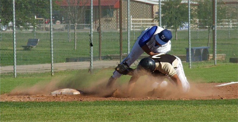 Image: Omar Estrada collides with Whitney’s third baseman while trying to steal third.