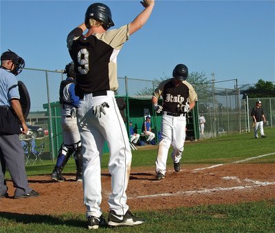 Image: Cody Boyd(9) signals to teammate Kyle Fortenberry(11) to come home standing up.