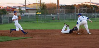 Image: Reid Jacinto gets caught in a run down but beats the throw to second base and slides under the tag.